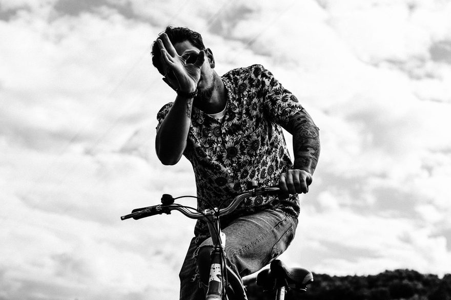 Petja on a bicycle, holding an OK sign in front of one eye